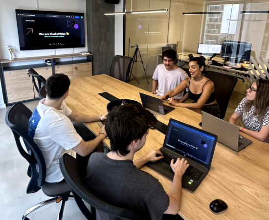 team of wisers looking at a whiteboard
